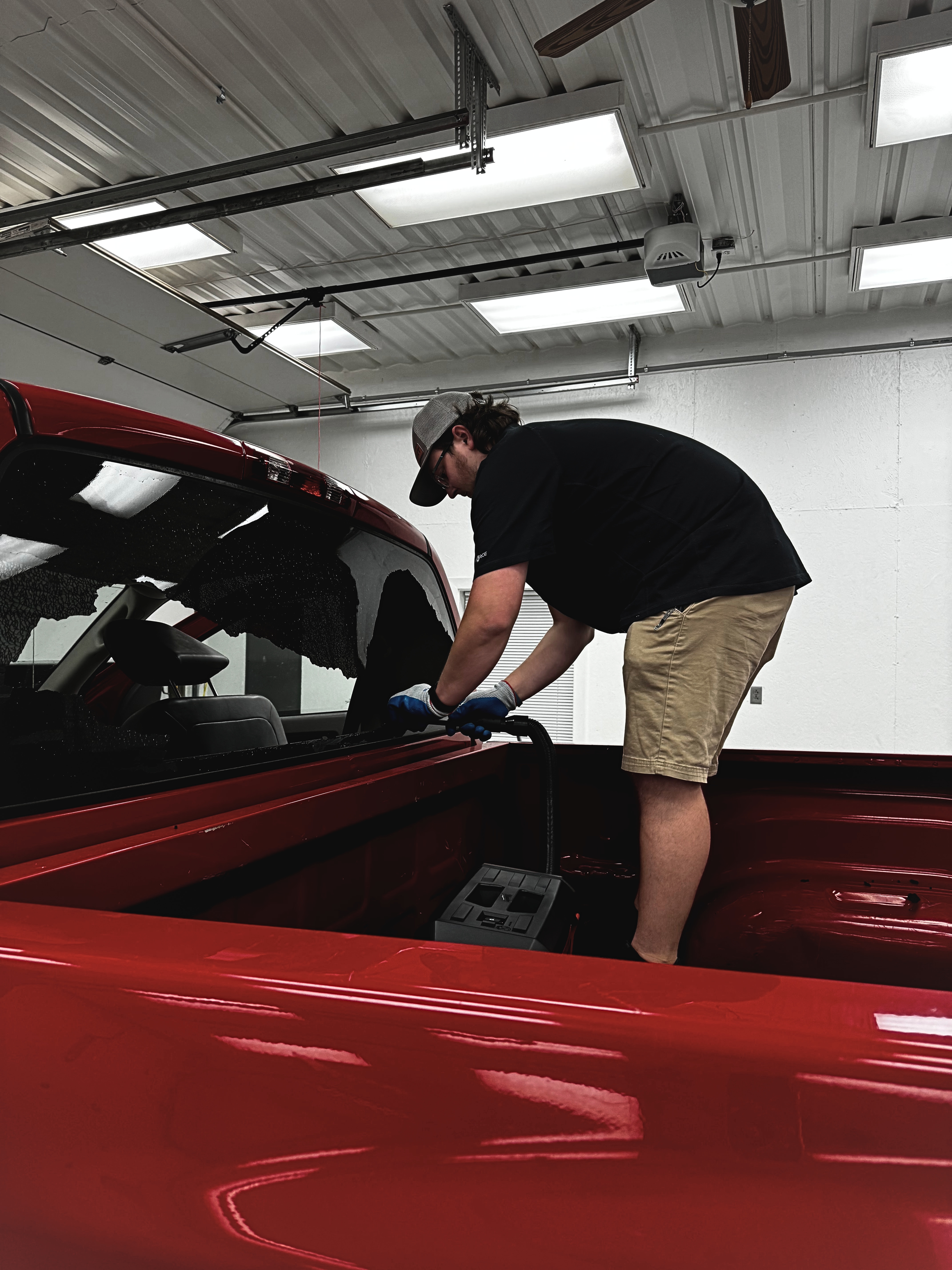 Rear glass replacement on red truck