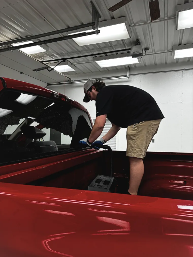 Rear glass replacement on red truck
