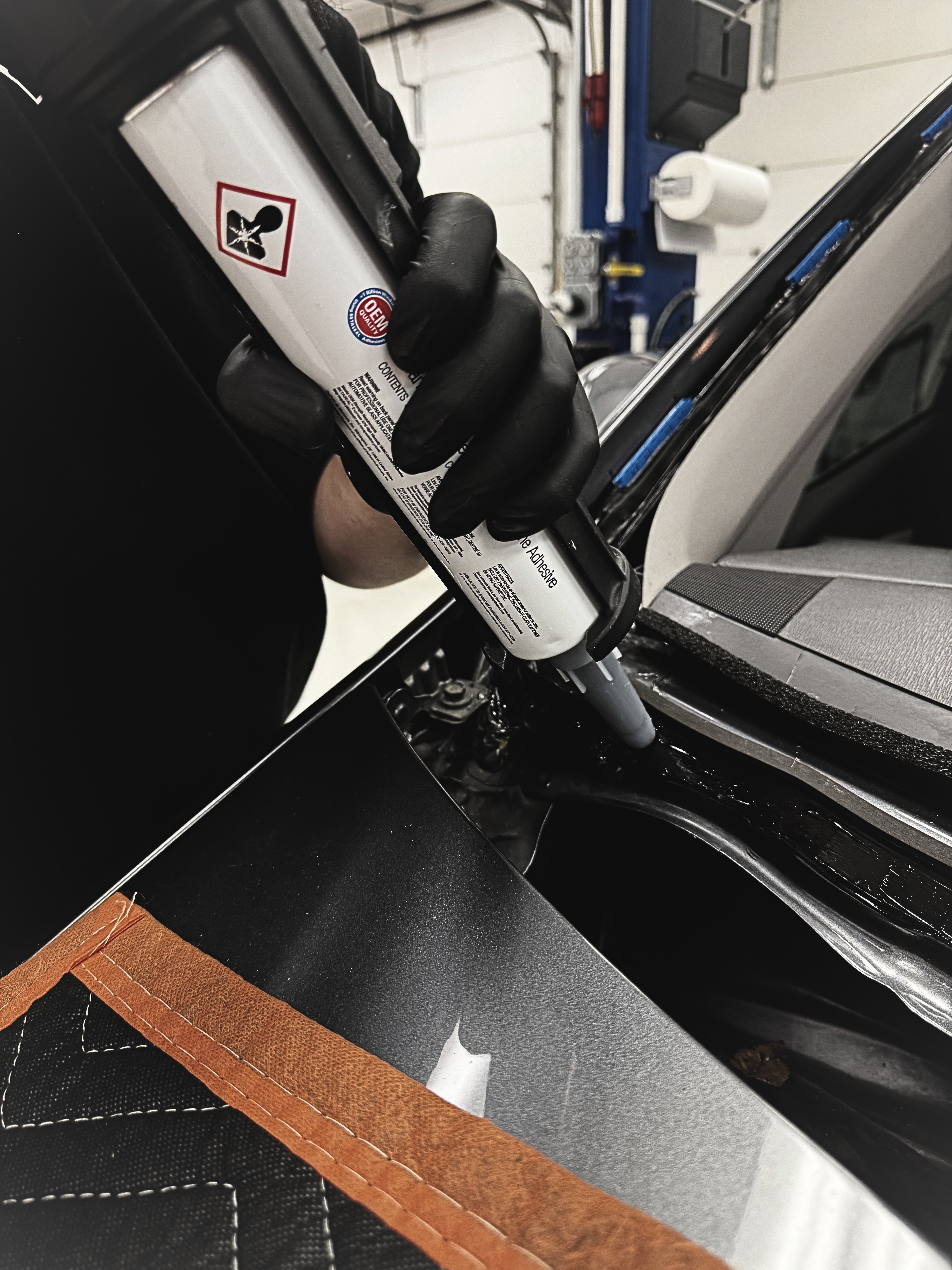 David Ping applying OEM urethane during windshield installation