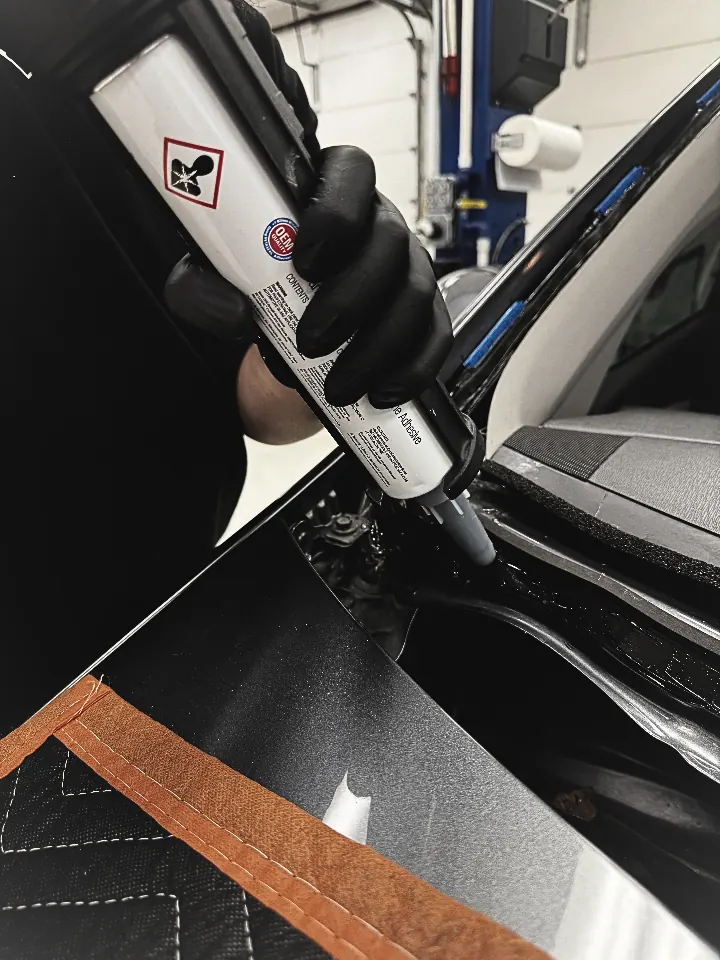 David Ping applying OEM urethane during windshield installation